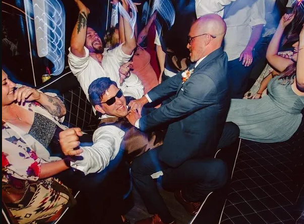 Guests dancing and celebrating at a wedding reception