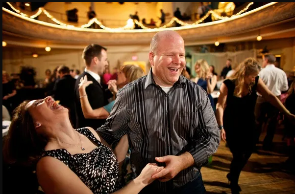 Couple dancing and laughing at an event
