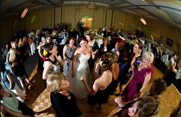 Bride surrounded by guests on the dance floor