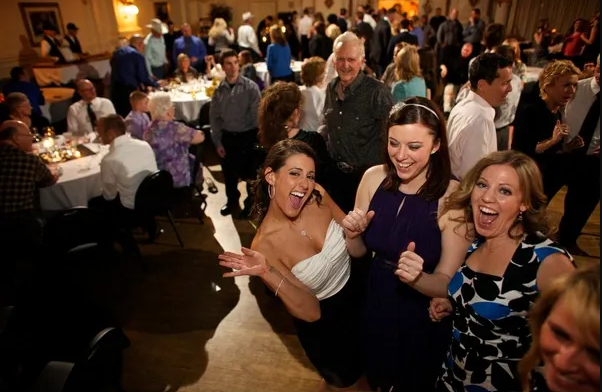 Bride and bridesmaids celebrating at a reception