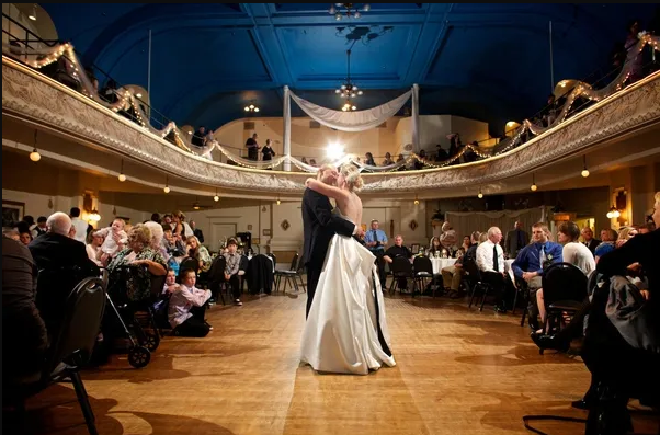 Couple sharing first dance in a grand ballroom
